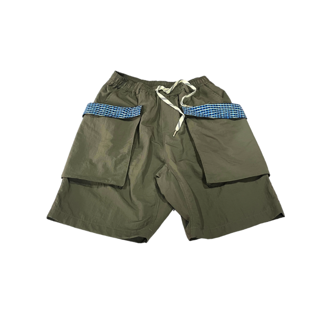 Green shorts with blue checkered trim on a white background